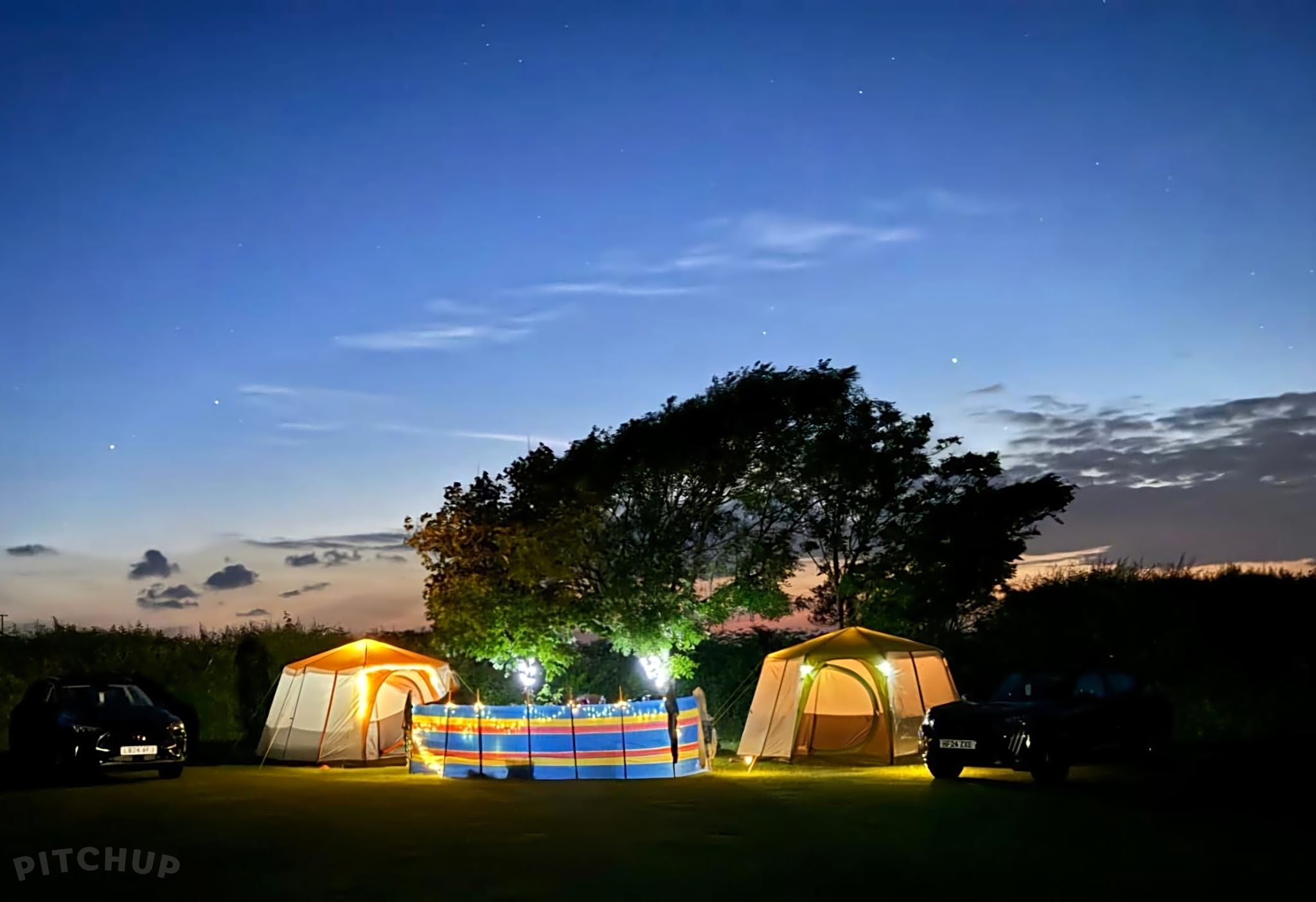 Camping setup overlooking Gower coastline with tents and sea views
