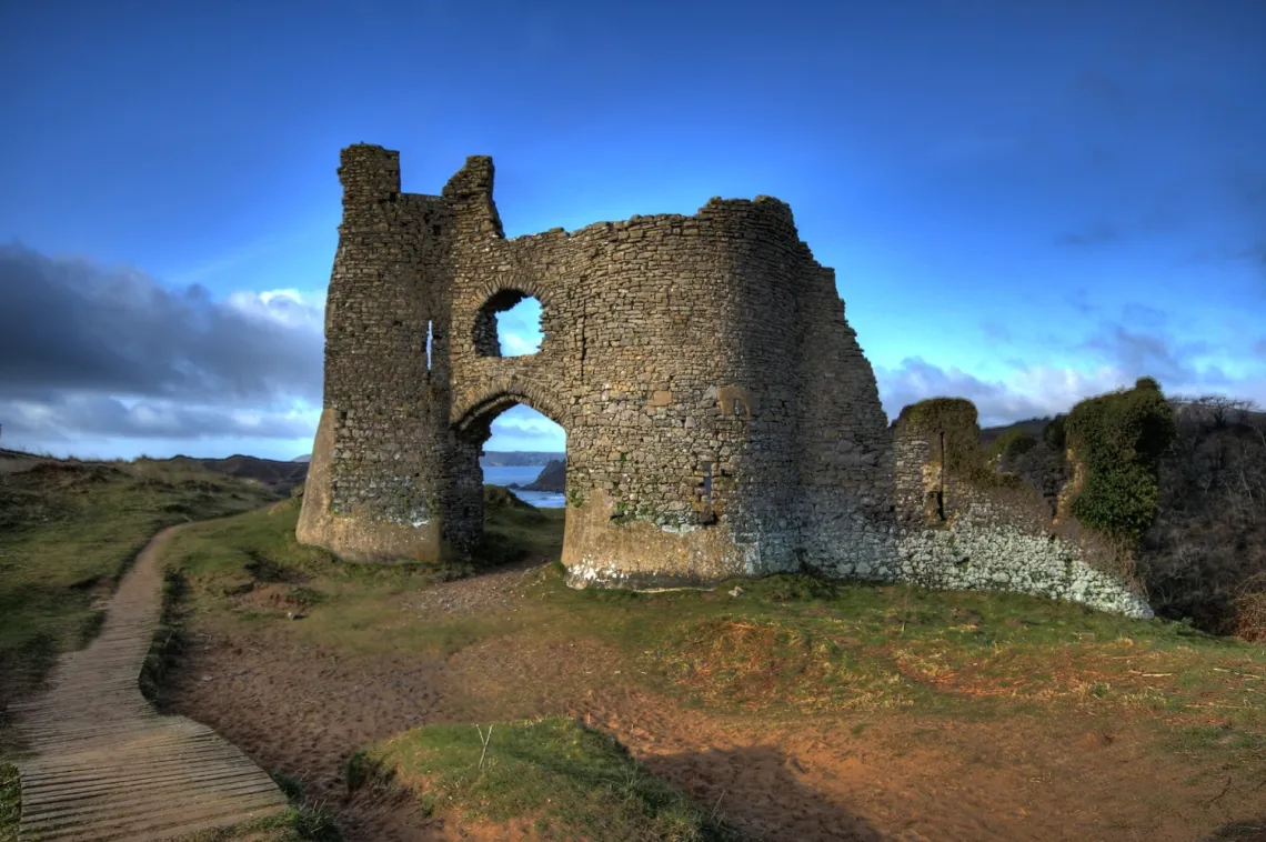 Historic castle ruins overlooking the Gower coastline and countryside